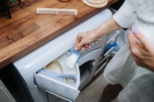no-head-image-woman-pouring-powder-washer-high-angle_352677-410