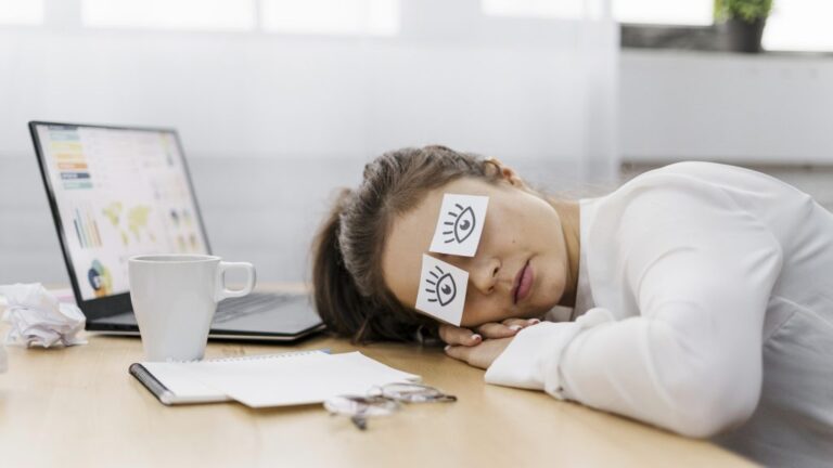 tired-businesswoman-covering-her-eyes-with-drawn-eyes-paper-1024x576-1